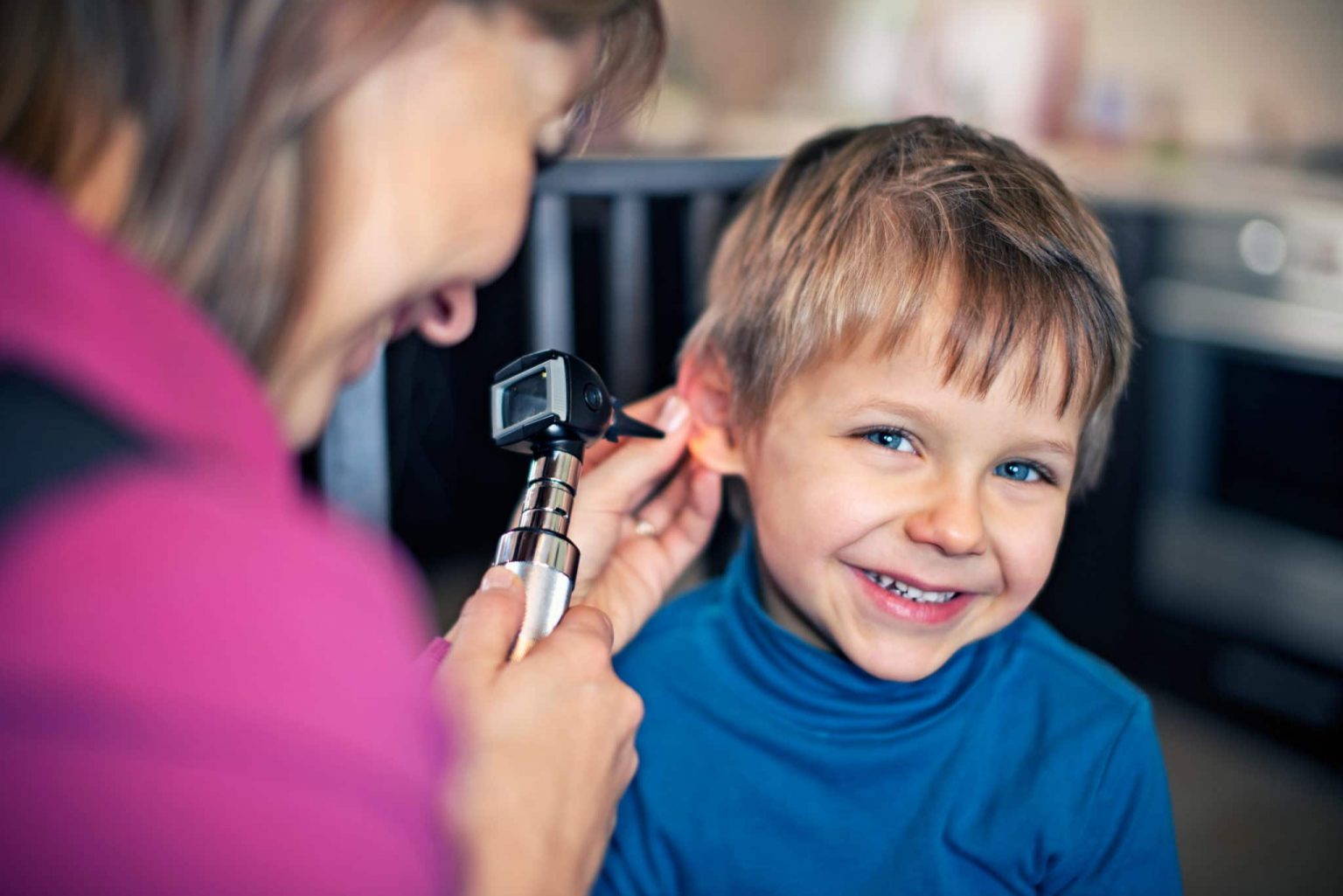 Ear Tube Treatment Checkup ENT checks child patients ears to determine ear tube effectiveness