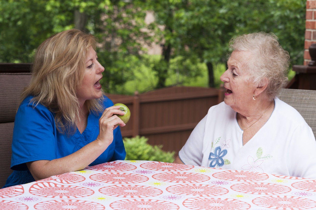 Woman works on speech skills with doctor