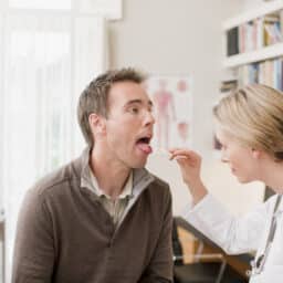 ENT looking at a patient's throat