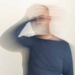 Close up photo of man with vertigo illness. Motion blur effect applied.