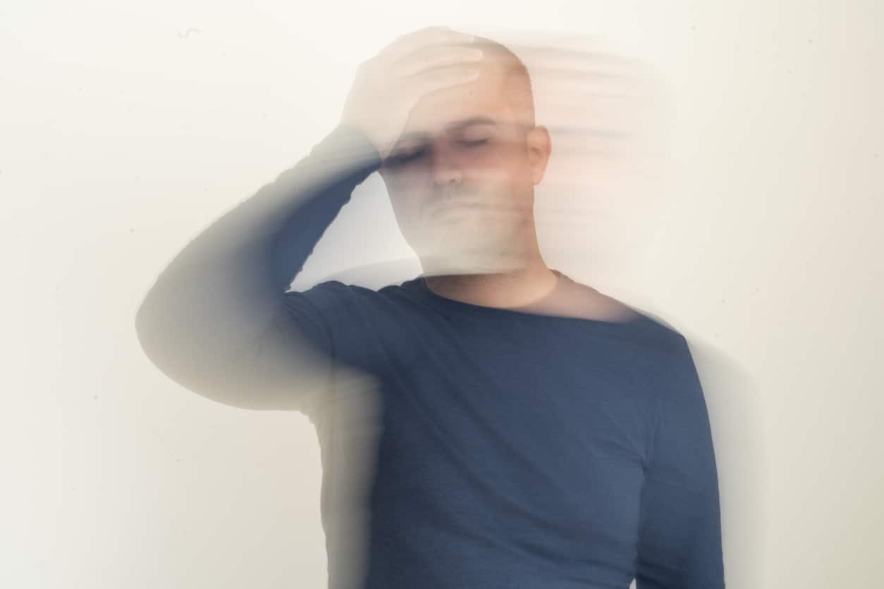 Close up photo of man with vertigo illness. Motion blur effect applied.