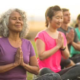 Tranquil group meditation class in a sunny park.