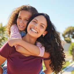 Happy mother and daughter hugging on a beautiful day.